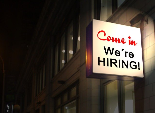We're hiring sign for new jobs on a darkened alley