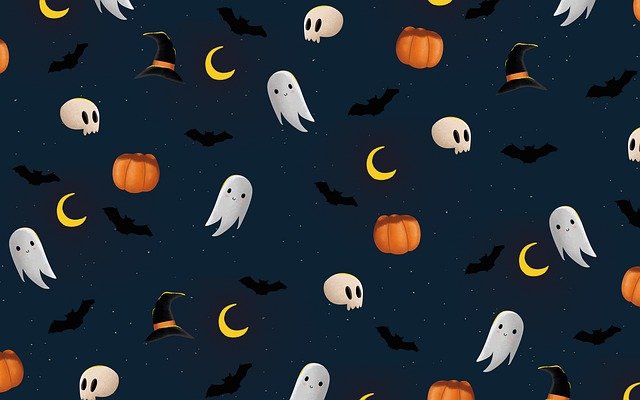 Spooky halloween wallpaper with pumpkins, ghosts, and witches' hats