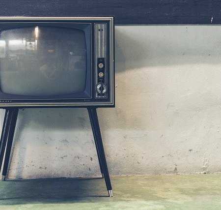 An old TV standing against a wall