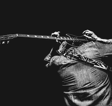 Man showing off playing a guitar