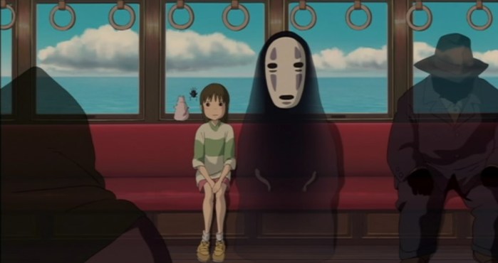 Sen and No Face sitting on a train in Spirited Away