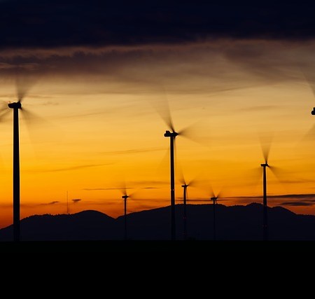 Wind turbines in a sunset creating gusts