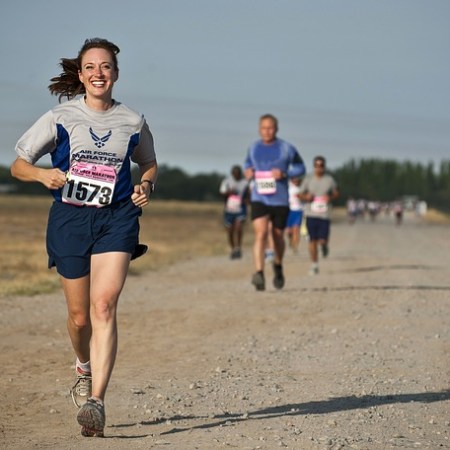 A female runner smiling like crazy