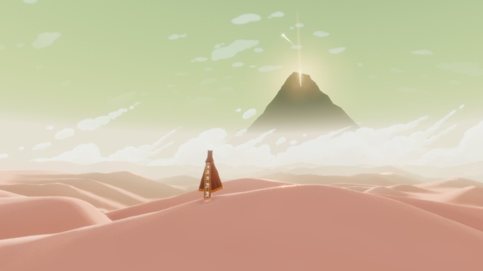 Journey game- robed figure in the desert with a mountain ahead