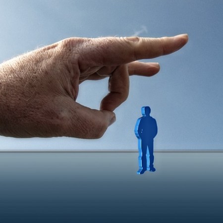 A giant hand flicking a man figure, firing the employee immediately