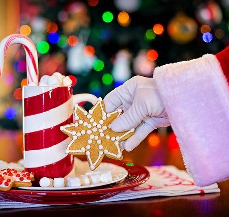 Santa Claus picking up a Christmas item