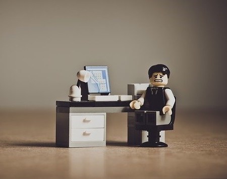 A LEGO employee looking unhappy in the workplace