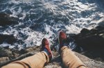 Man feet set against the backdrop of the ocean