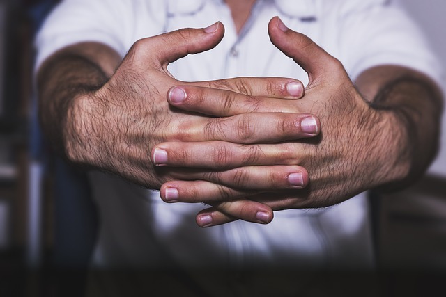 A man holding his hands out to crack his knuckles