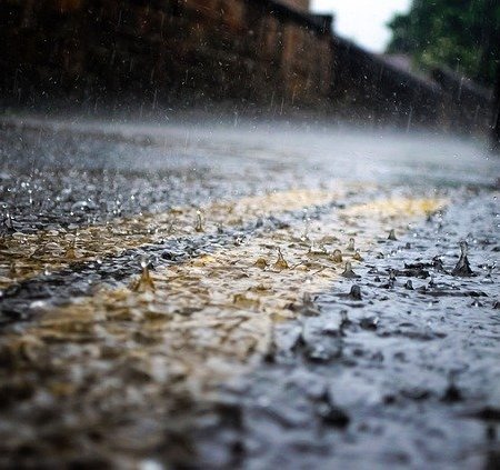 Heavy rain on a street with parking lines
