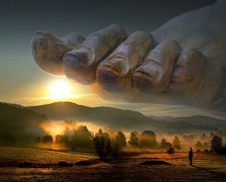 A giant foot with toenails about to stamp on idyllic countryside