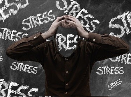A man holding his head in stress