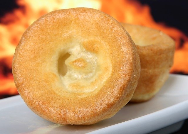 Two Yorkshire puddings with fire in the background