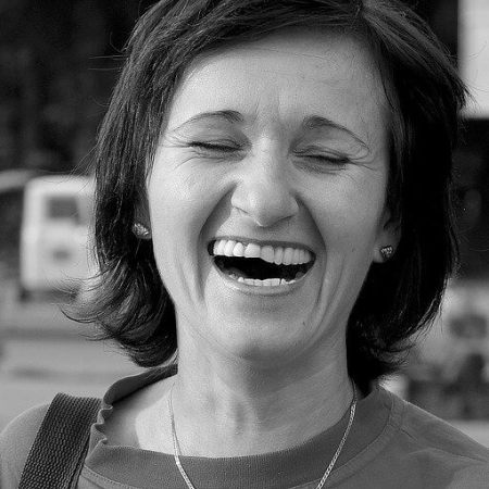 A woman laughing.