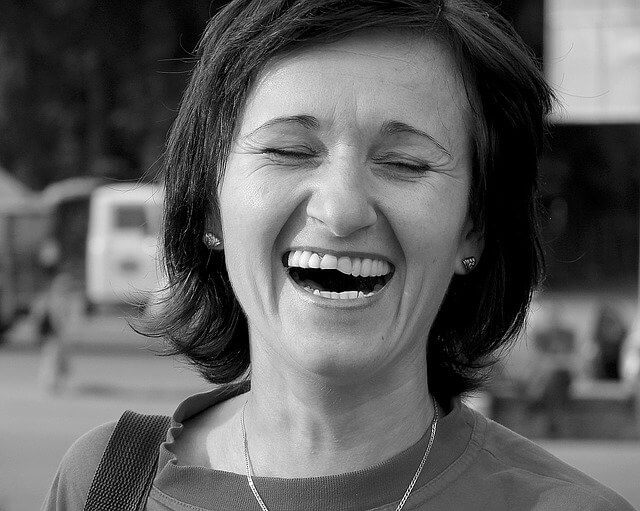 A woman laughing.