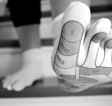 Someone walking down stairs with a close up of a big toe