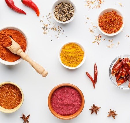 Spices laid out on a table, including turmeric
