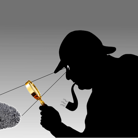 A detective examining some fingerprints