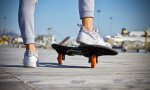 A pair of women's feet on a skateboard