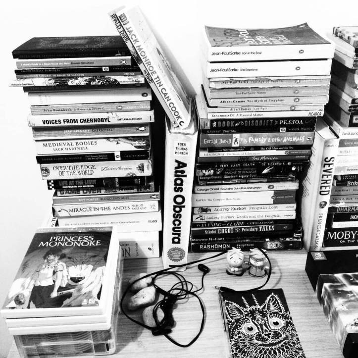 A book collection in black and white, with a DVD of Princess Mononoke