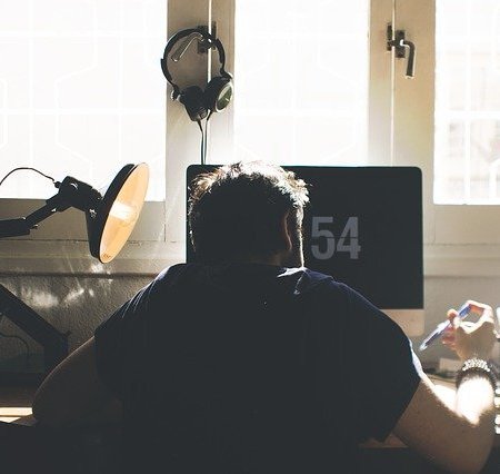 An employee slouching at his desk at work