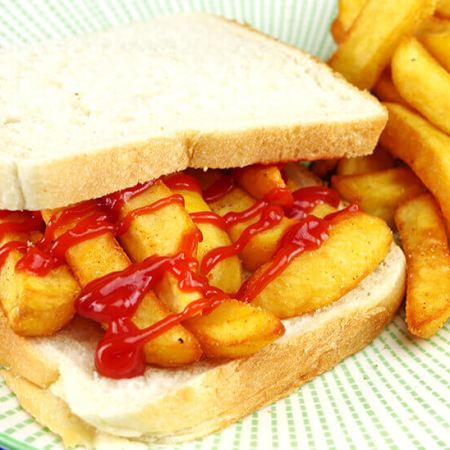 A chip butty with ketchup