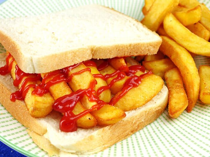 A chip butty with ketchup