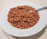 Baked beans in a plate with a fork
