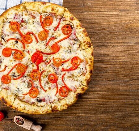 A freshly baked pizza cooling for a moment on a work surface
