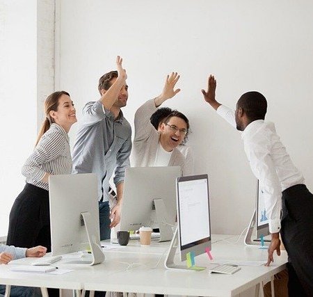A team of colleagues performing a high five