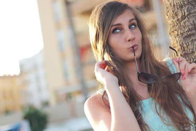 A woman posing and doing duck lips