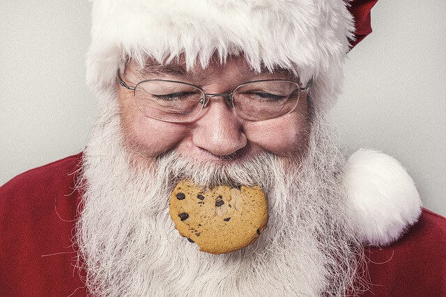 Santa Claus eating a chocolate chip cookie