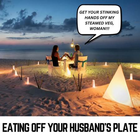 A wife stealing of her husband's plate during a romantic meal