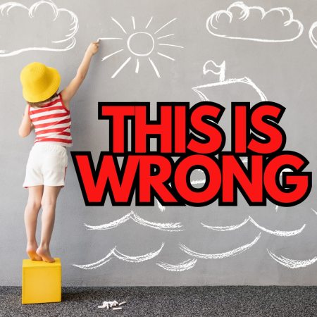 A child drawing on a wall which is just plain wrong